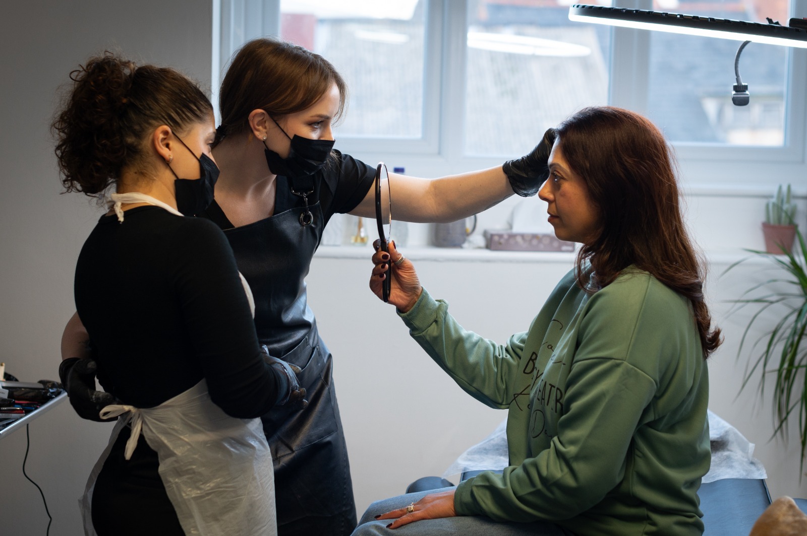 Instructor demonstrating technique to student with client