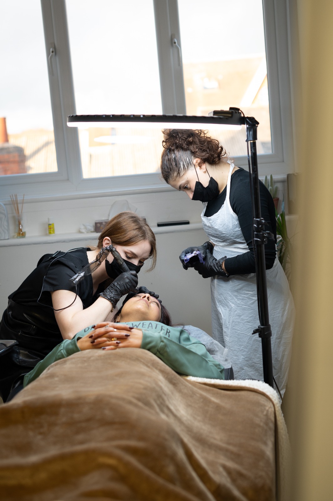 Student practicing under instructor supervision on live model